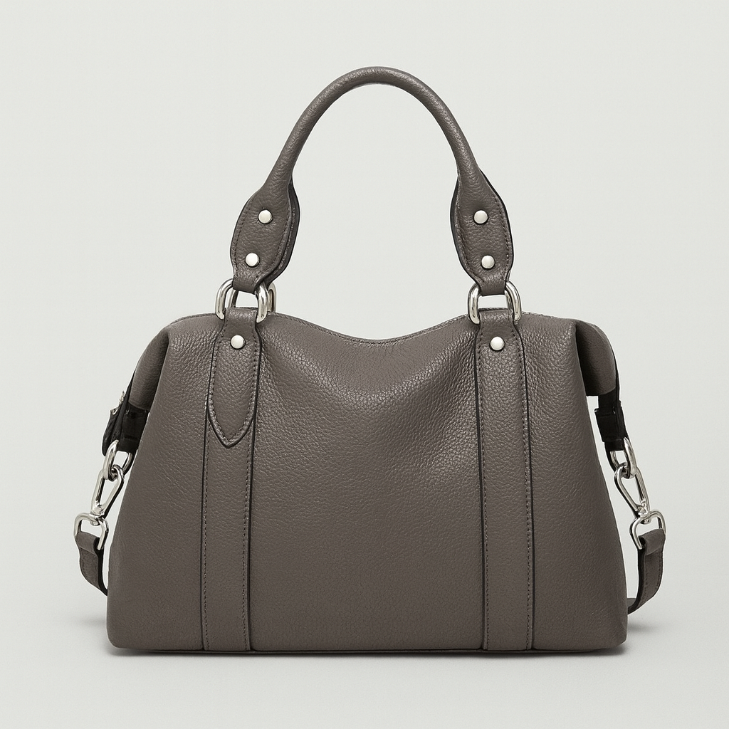 Medium structured handbag with dual handles and side strap details.