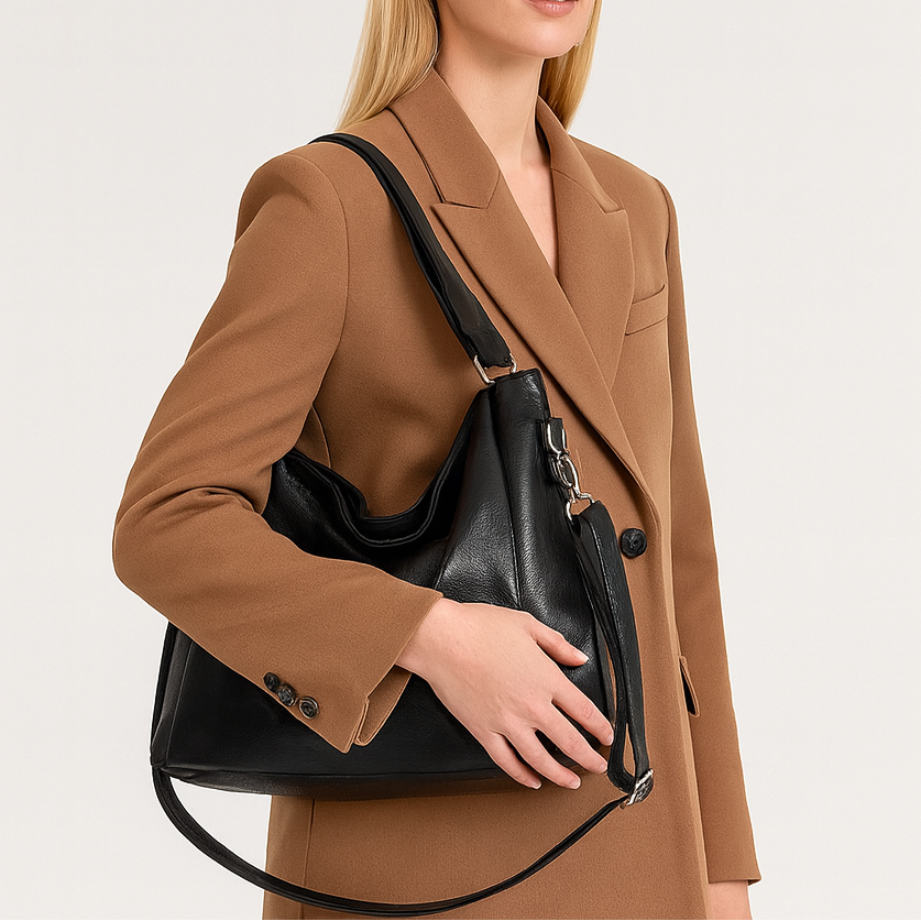 Large soft shoulder bag with dual handles and side strap details.