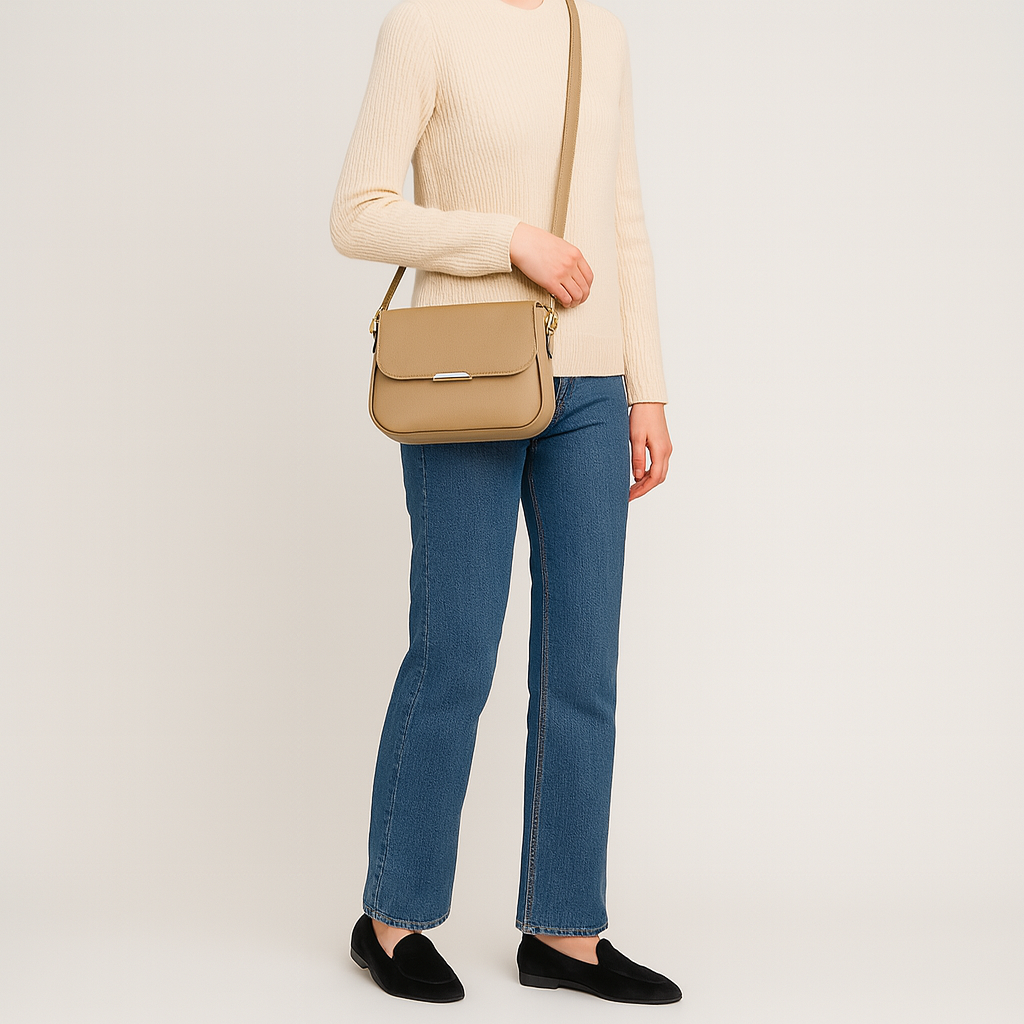 Crossbody bag with curved flap and slim shoulder strap.