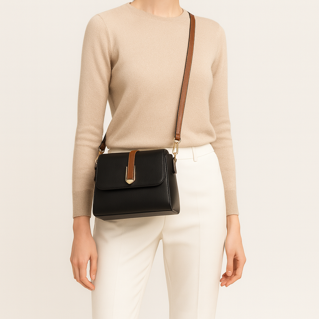 Structured crossbody bag with flap front and center buckle strap.