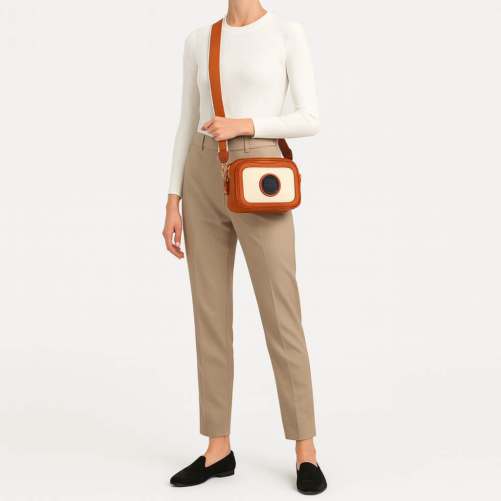 Crossbody bag with contrast trim and wide shoulder strap.