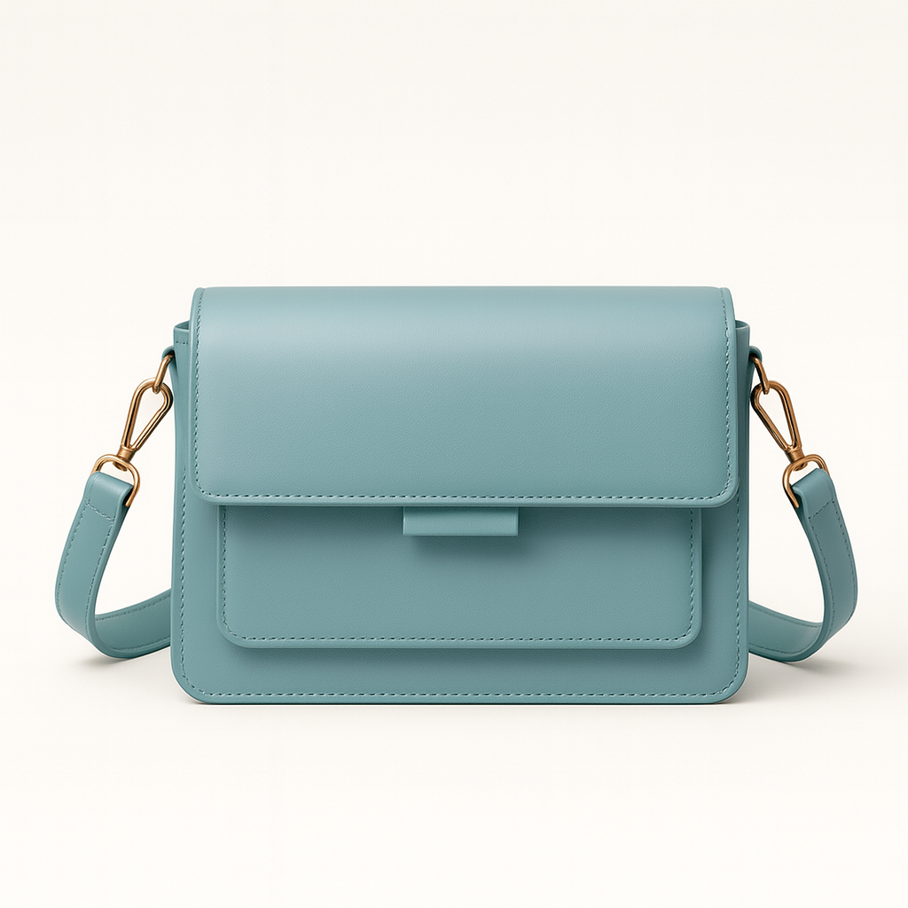 Structured crossbody bag with flap front and adjustable strap.