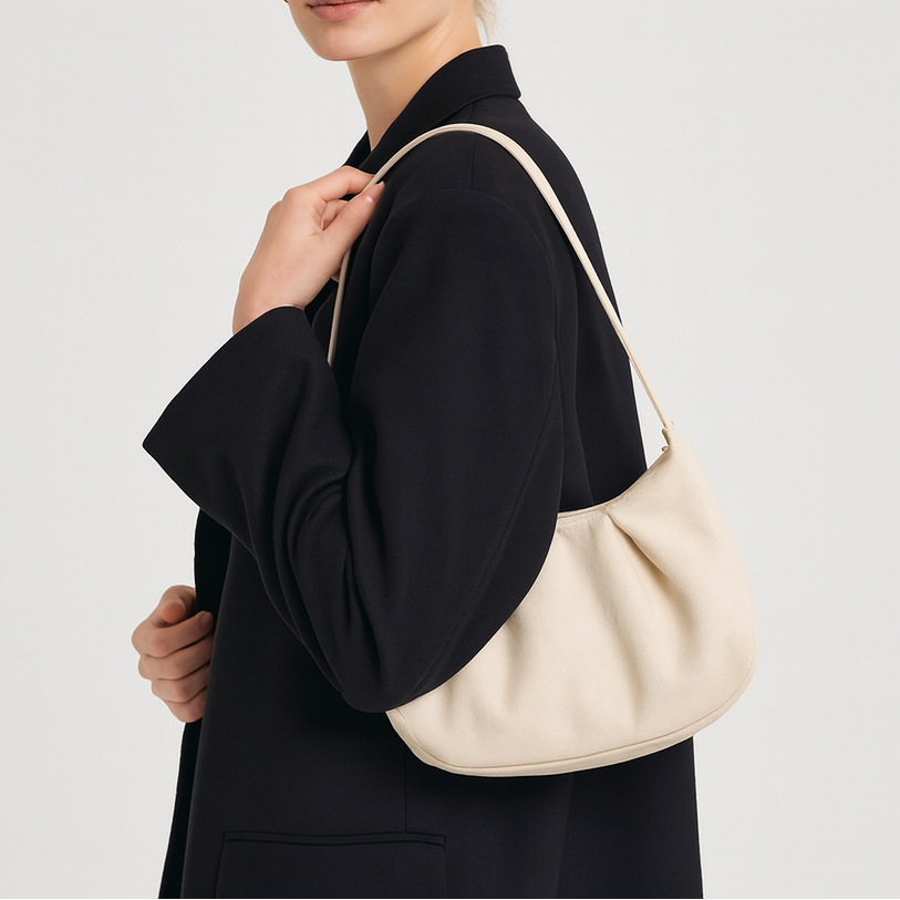 Small structured shoulder bag with a short strap.