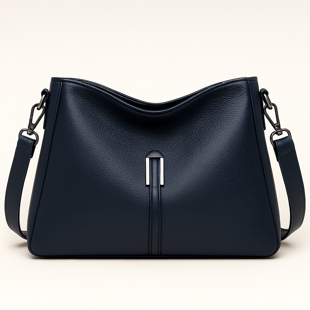 Soft-structured shoulder bag with single metal accent and adjustable strap.
