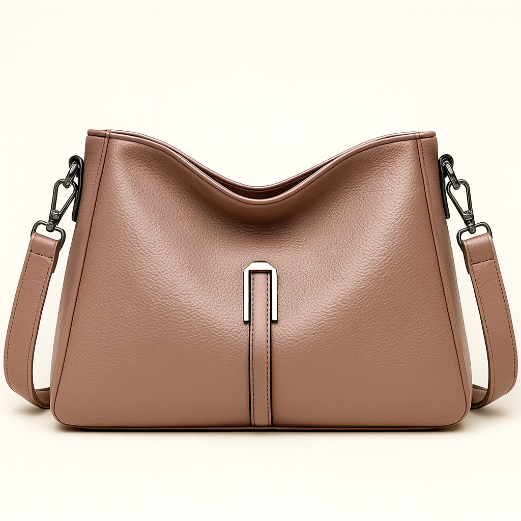 Soft-structured shoulder bag with single metal accent and adjustable strap.