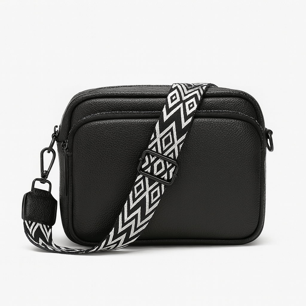 Crossbody bag with zip pocket and patterned strap.