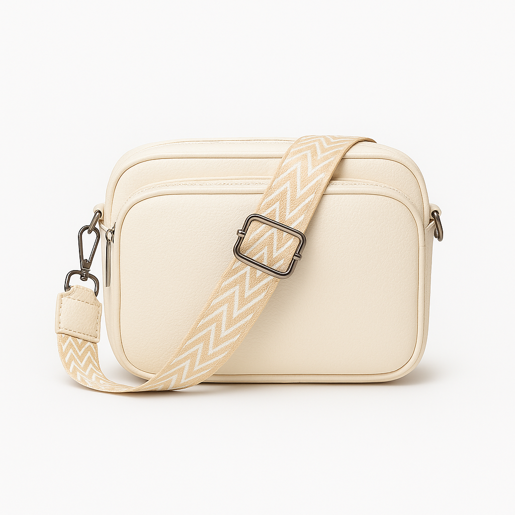 Crossbody bag with zip pocket and patterned strap.