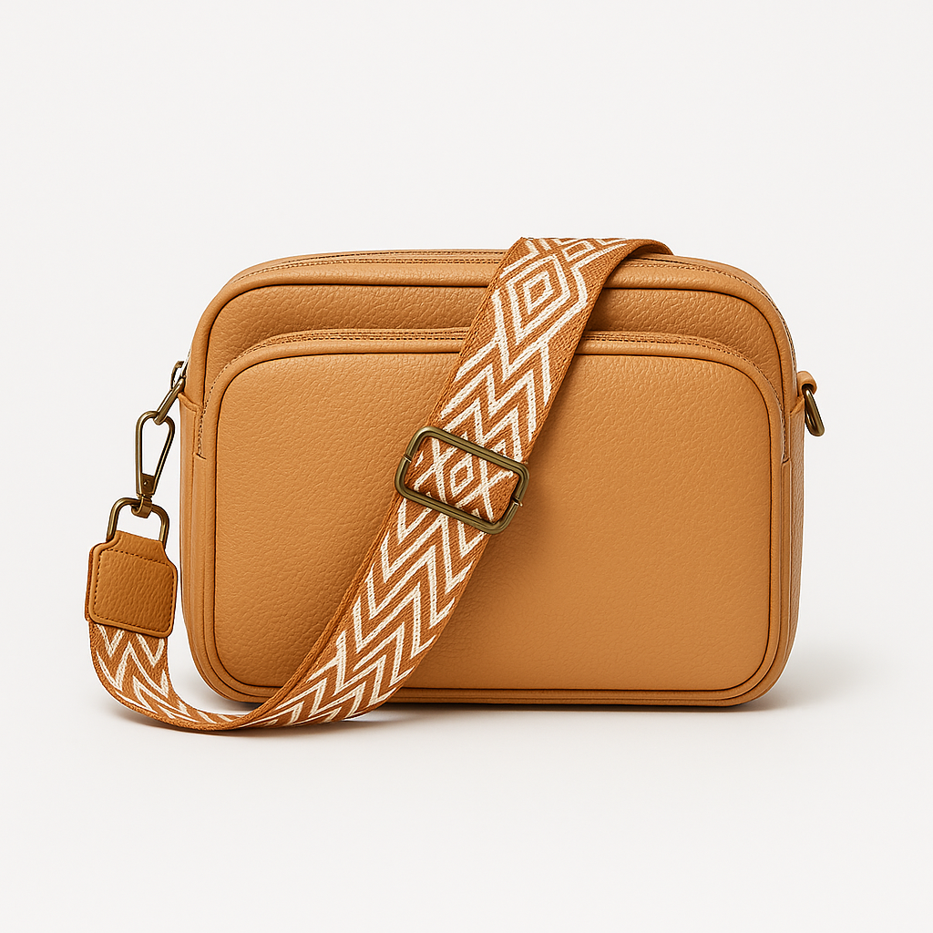 Crossbody bag with zip pocket and patterned strap.