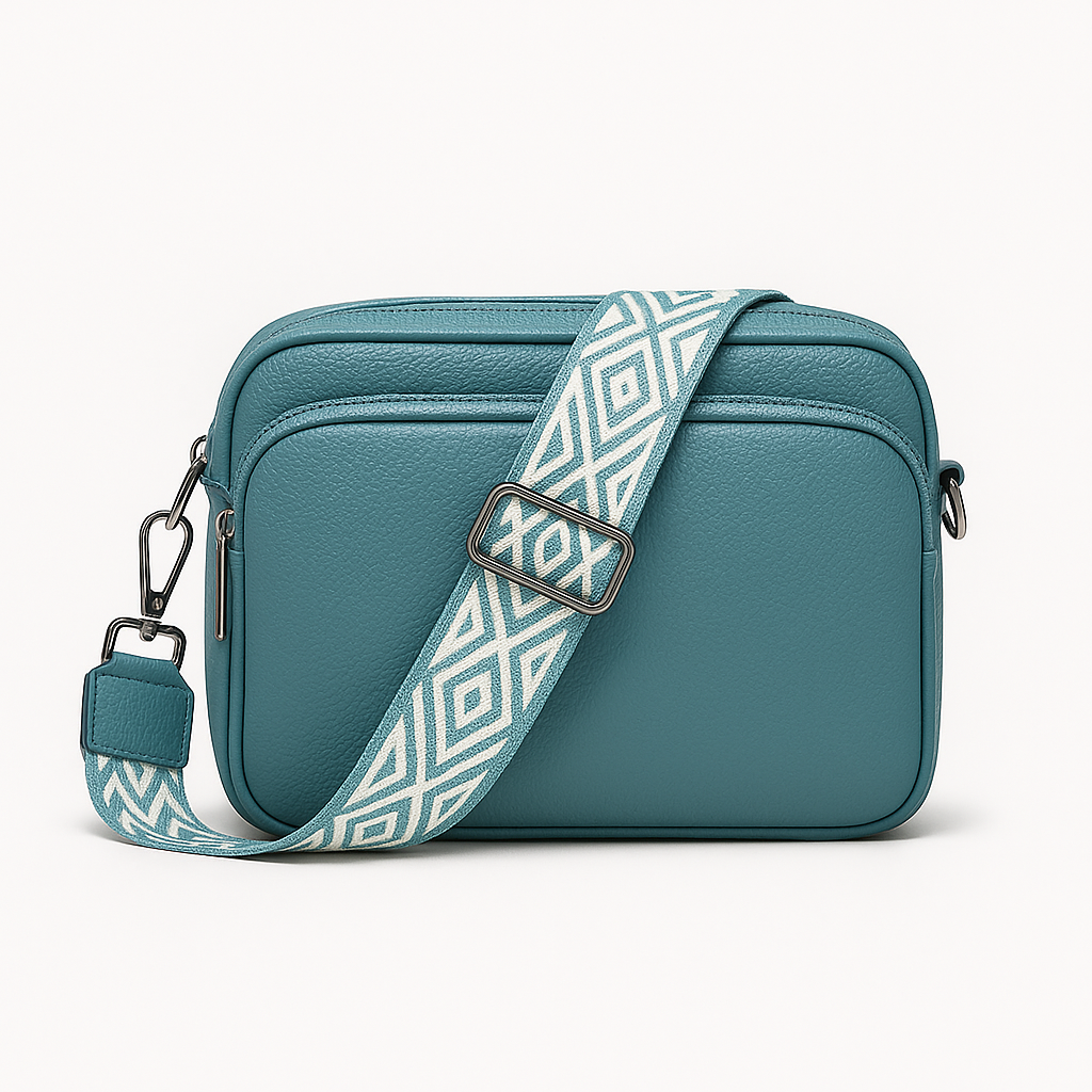 Crossbody bag with zip pocket and patterned strap.